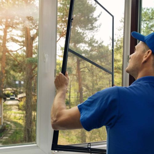 Smart home: man controlling blinds with app on his phone
